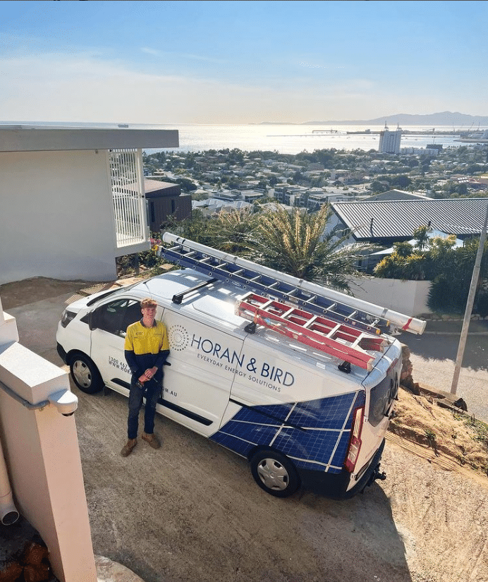 Horan and Bird Installation van and technician standing on a driveway with a picturesque view