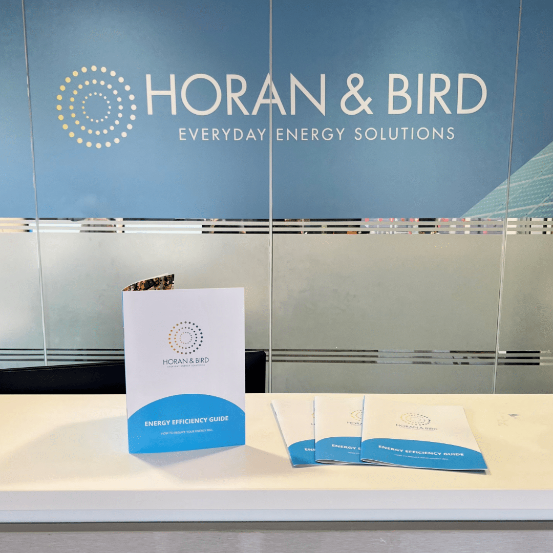 Horan and Bird Energy Efficiency Guide display on a table in front of a glass wall with Horan and Bird logo