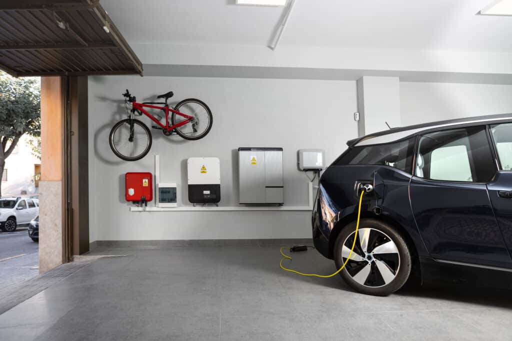 Car inside a garage plugged into an EV charging port