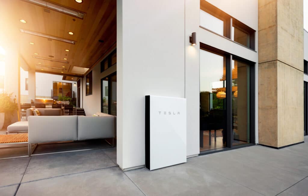 image of a house, featuring a solar home battery from Tesla