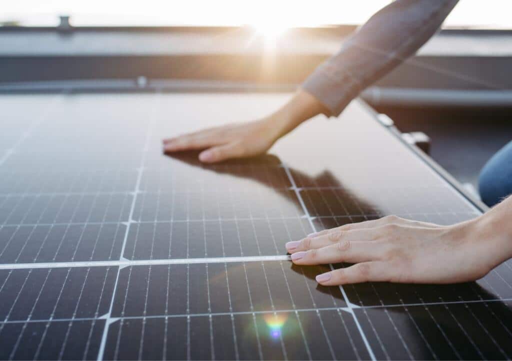 hands touching solar panel